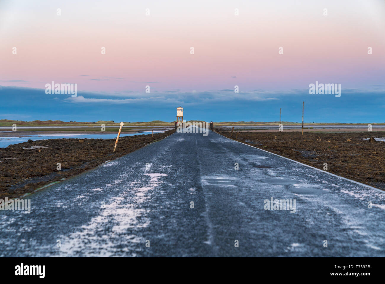 Sign: Single File Traffic, Danger do not proceed when water reaches causeway, seen on the road between Beal and Holy Island in Northumberland, England Stock Photo