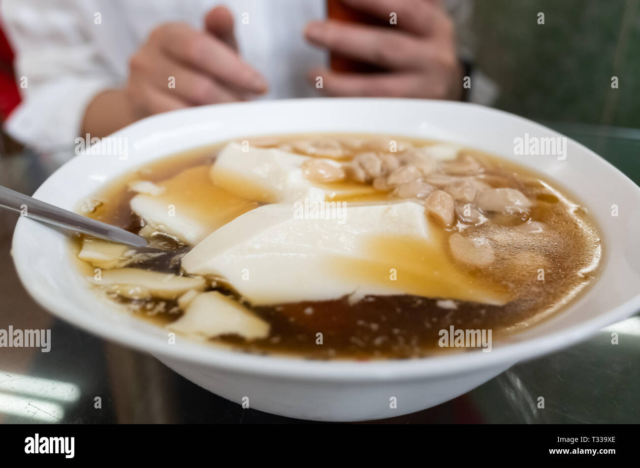 woman eat famous Taiwan snacks of tofu pudding Stock Photo Alamy