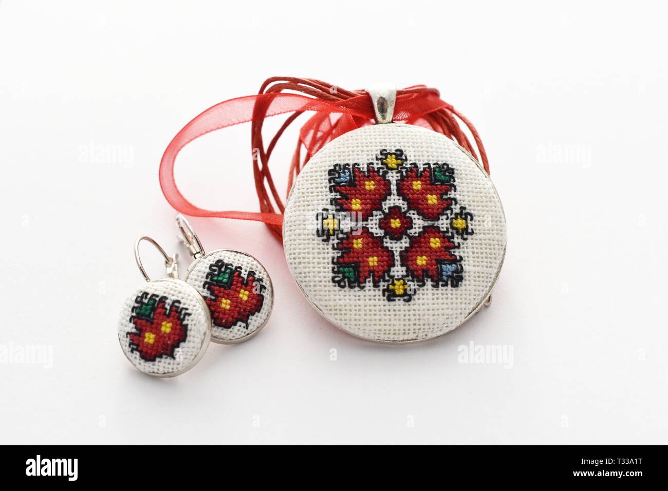 Handmade Cross stitch Earrings Red Earrings embroidered on white plastic  canvas Stock Photo - Alamy