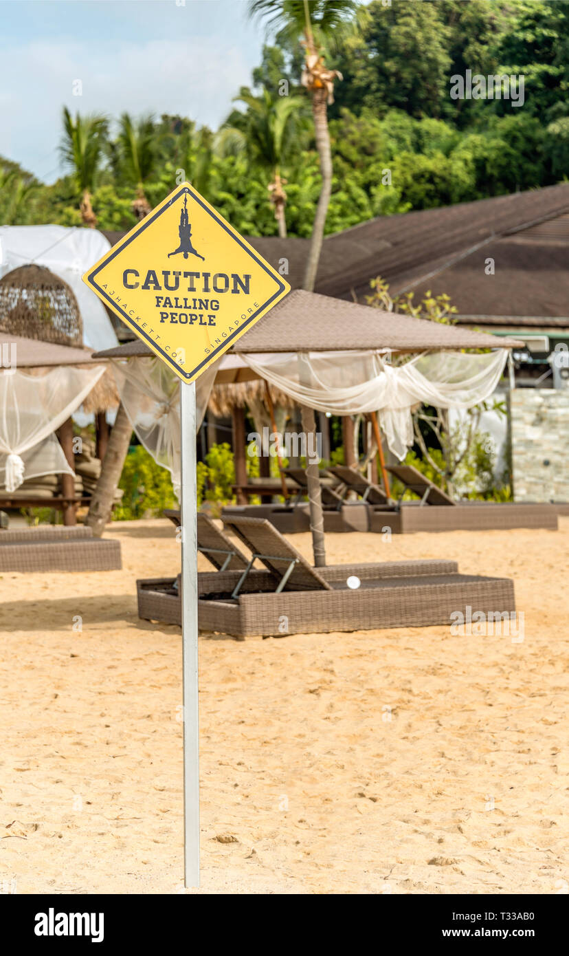'Falling People' warning signboard at Siloso Beach on Sentosa Island, Singapore Stock Photo
