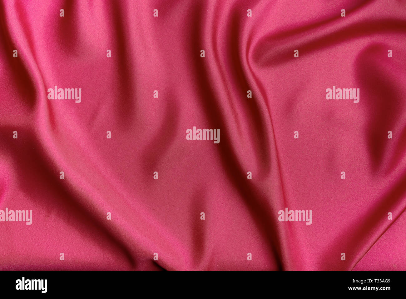 Red silk canvas cloth waves background or texture Stock Photo