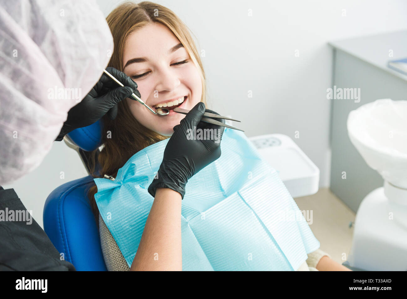 Dental clinic. Reception, examination of the patient. Teeth care. Young girl undergoes a dental