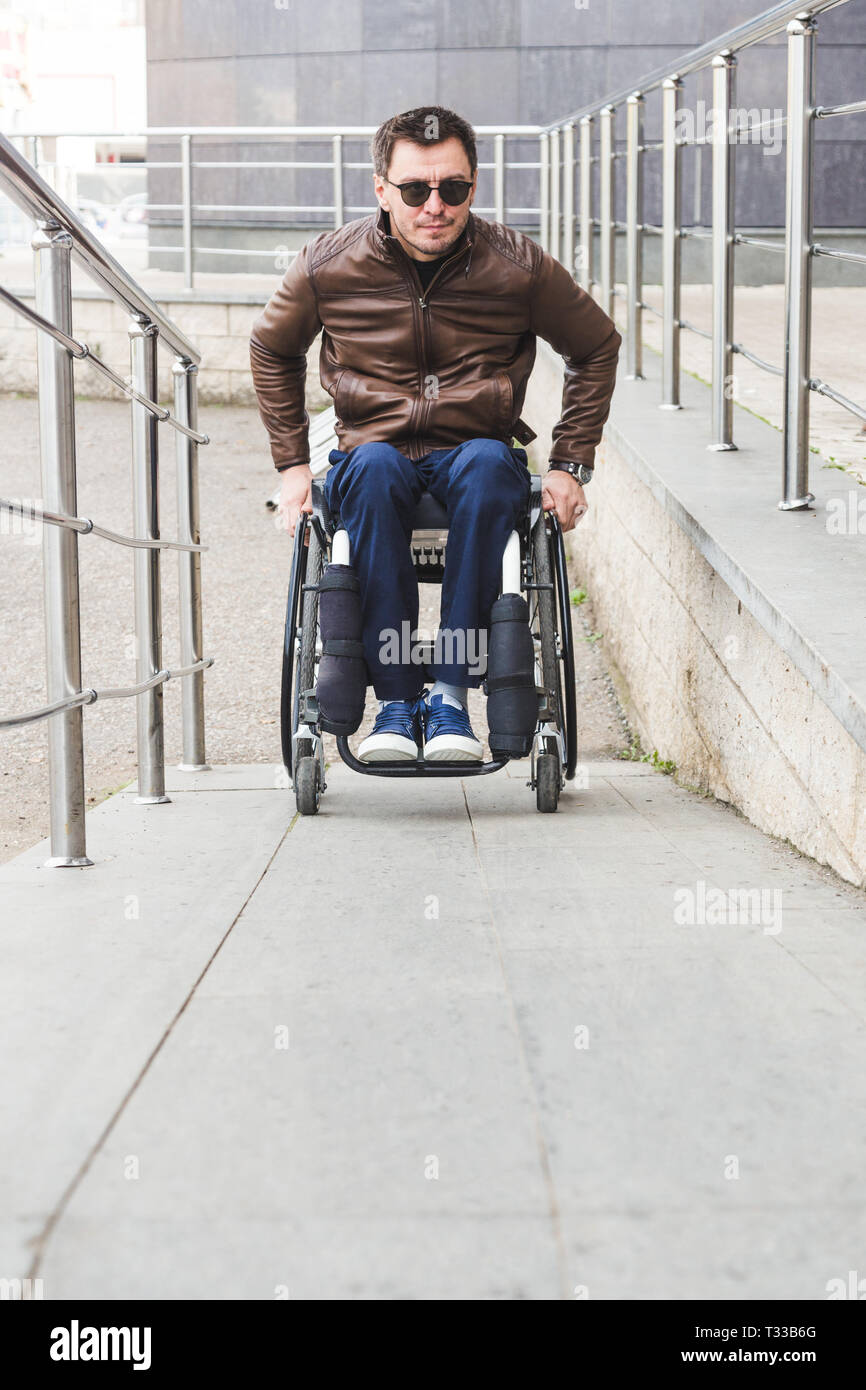 Man in a wheelchair hi-res stock photography and images - Alamy