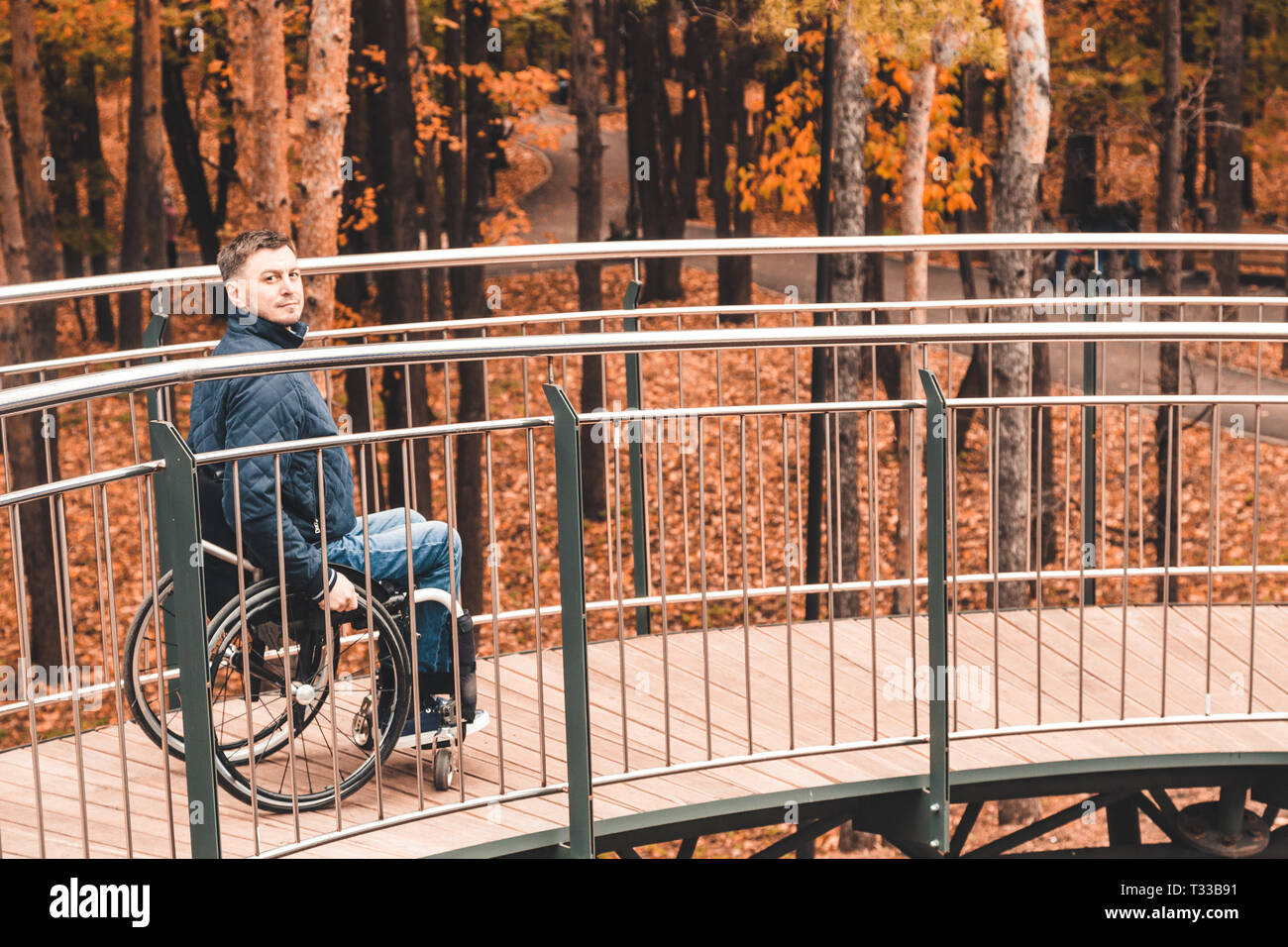 Man in a wheelchair use a wheelchair ramp Stock Photo - Alamy