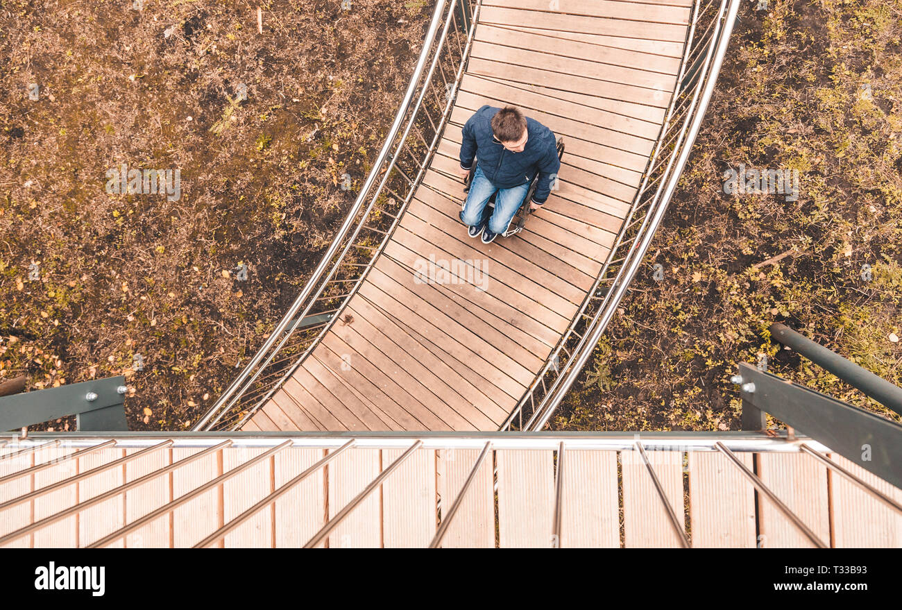 Man in a wheelchair use a wheelchair ramp Stock Photo - Alamy
