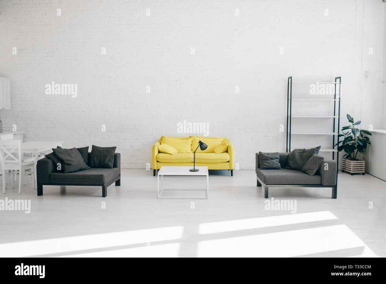 Modern Living Room Interior In White Black And Yellow Tones