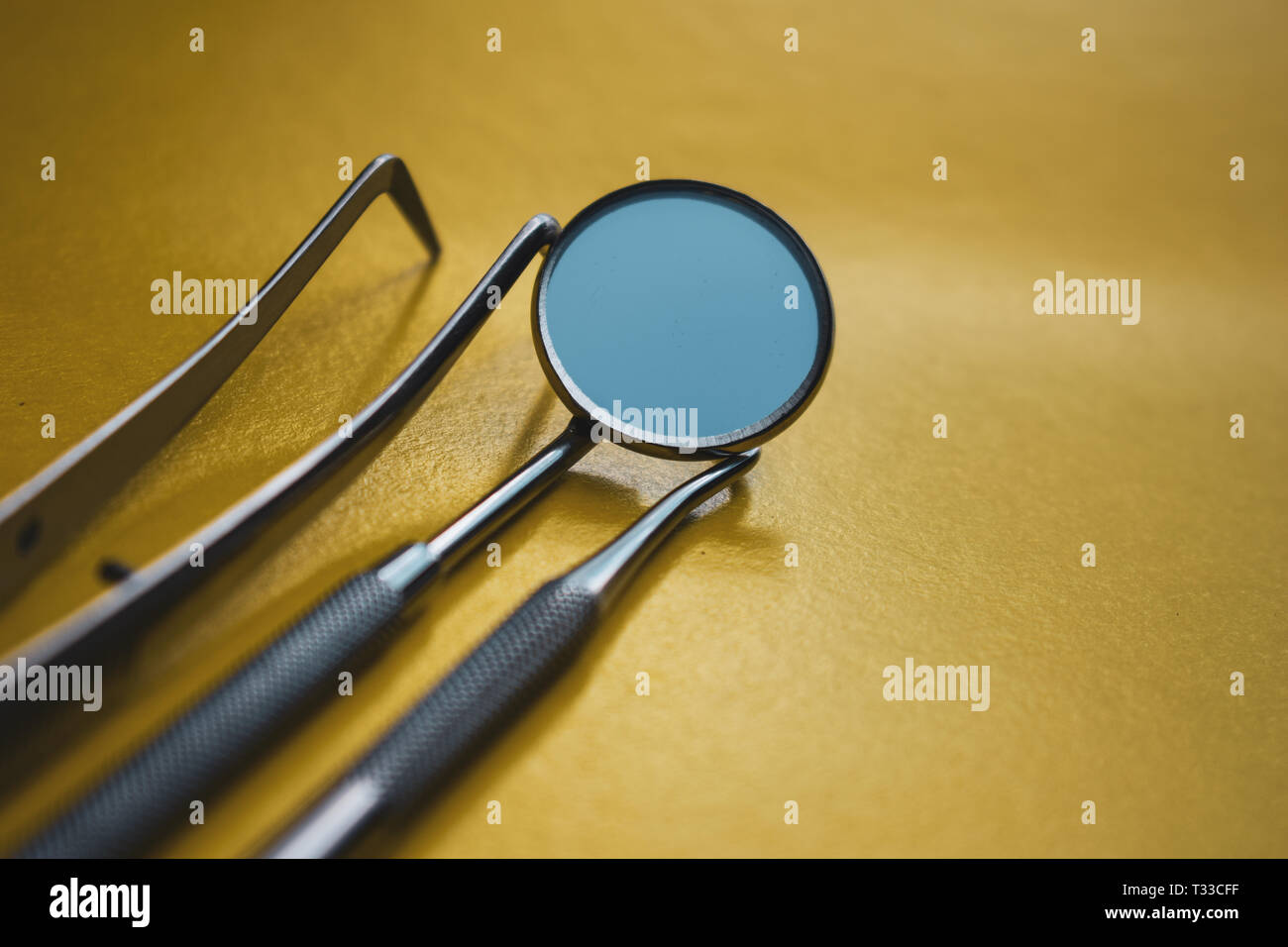 Close-up Dental Instruments on a yellow background. Prevention of oral diseases. Stock Photo