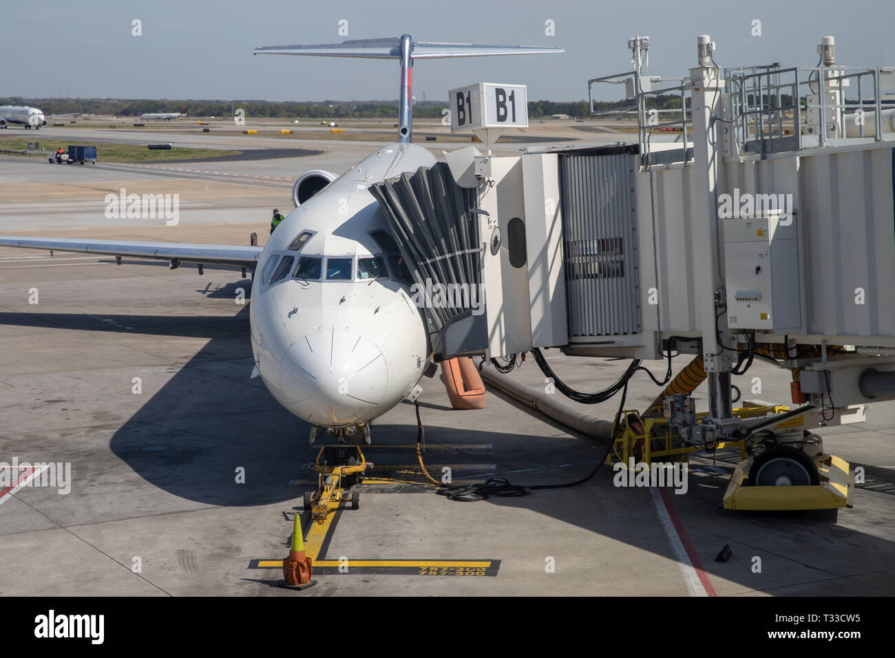 Commercial Aircraft parked at gate with jet bridge for passenger boarding Stock Photo