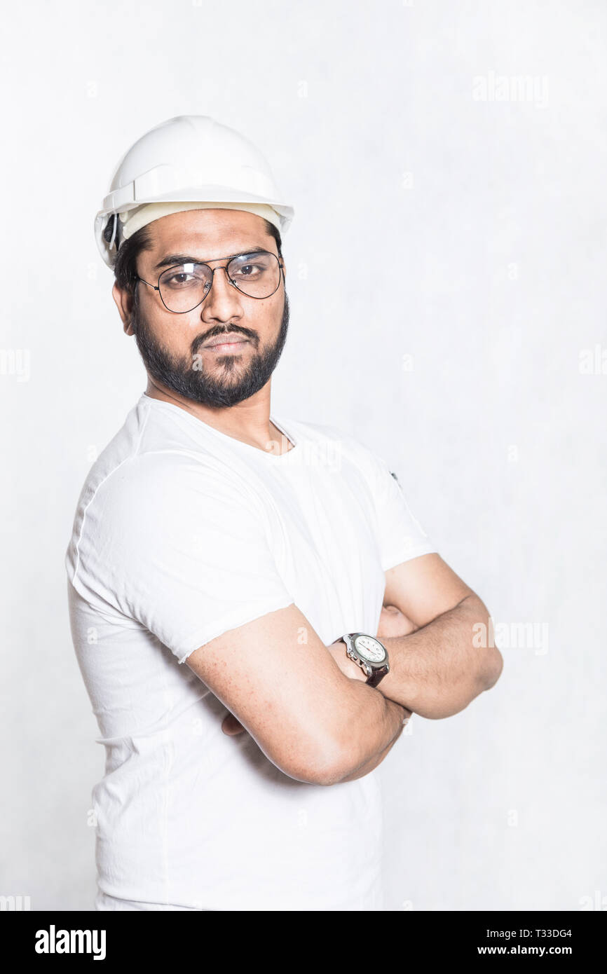 Young builder engineer with glasses and a white protective helmet Stock Photo