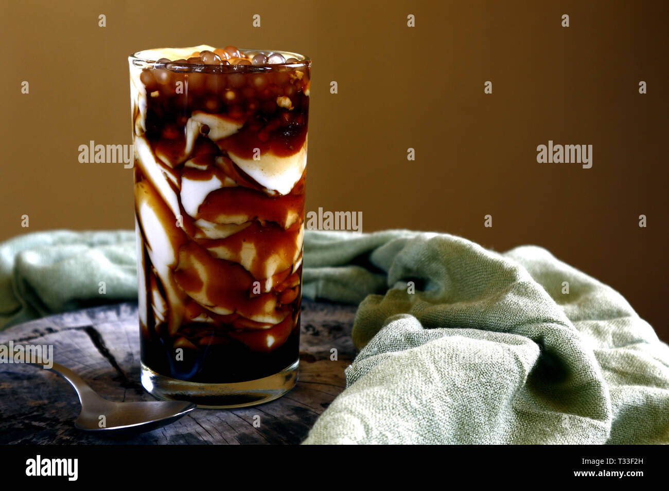 Photo of soy bean curd with caramel syrup and tapioca pearls or locally