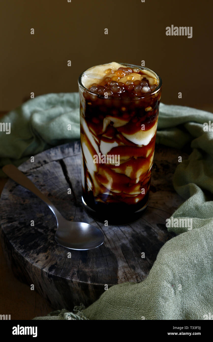 Photo of soy bean curd with caramel syrup and tapioca pearls or locally