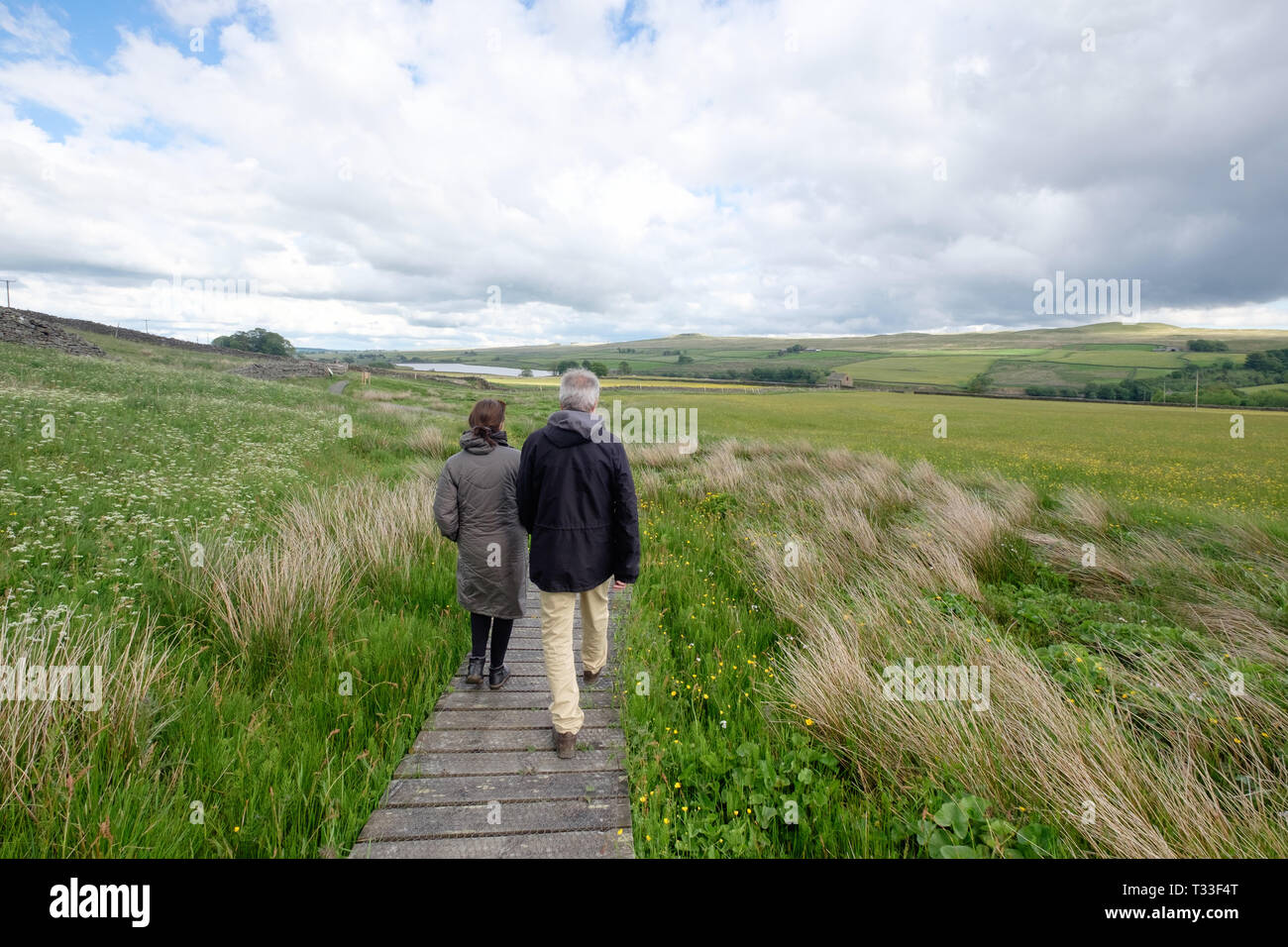 A couple visit the Hannah's Meadow Nature Reserve, part of the Durham Wildlife Trust in Teesdale, County Durham, Stock Photo