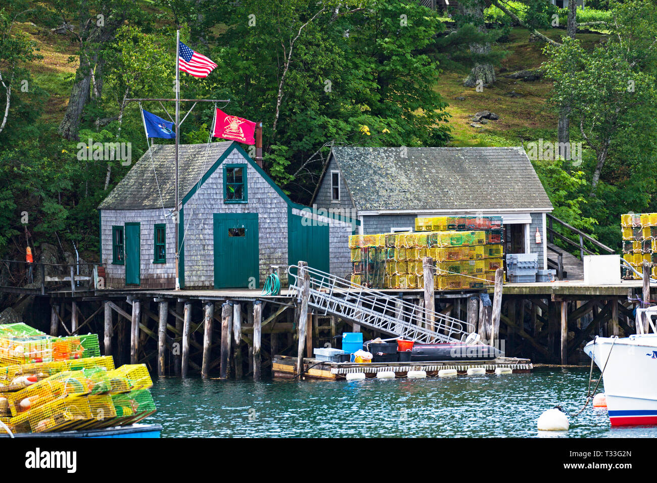 American and nautical flags fly over a small fishing shanty built on a
