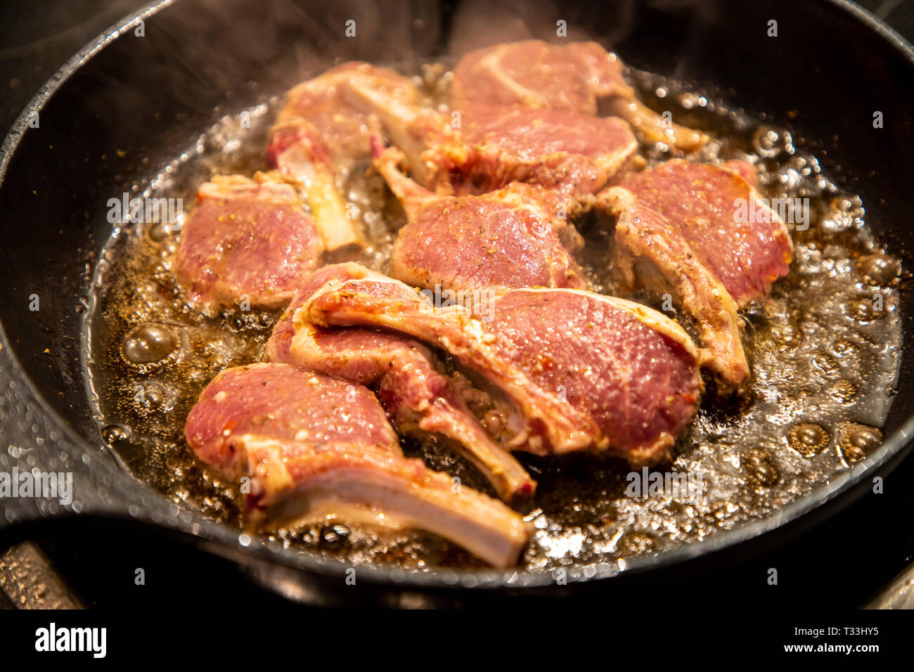 Cooking, meat, lamb chops are fried in a pan, Stock Photo