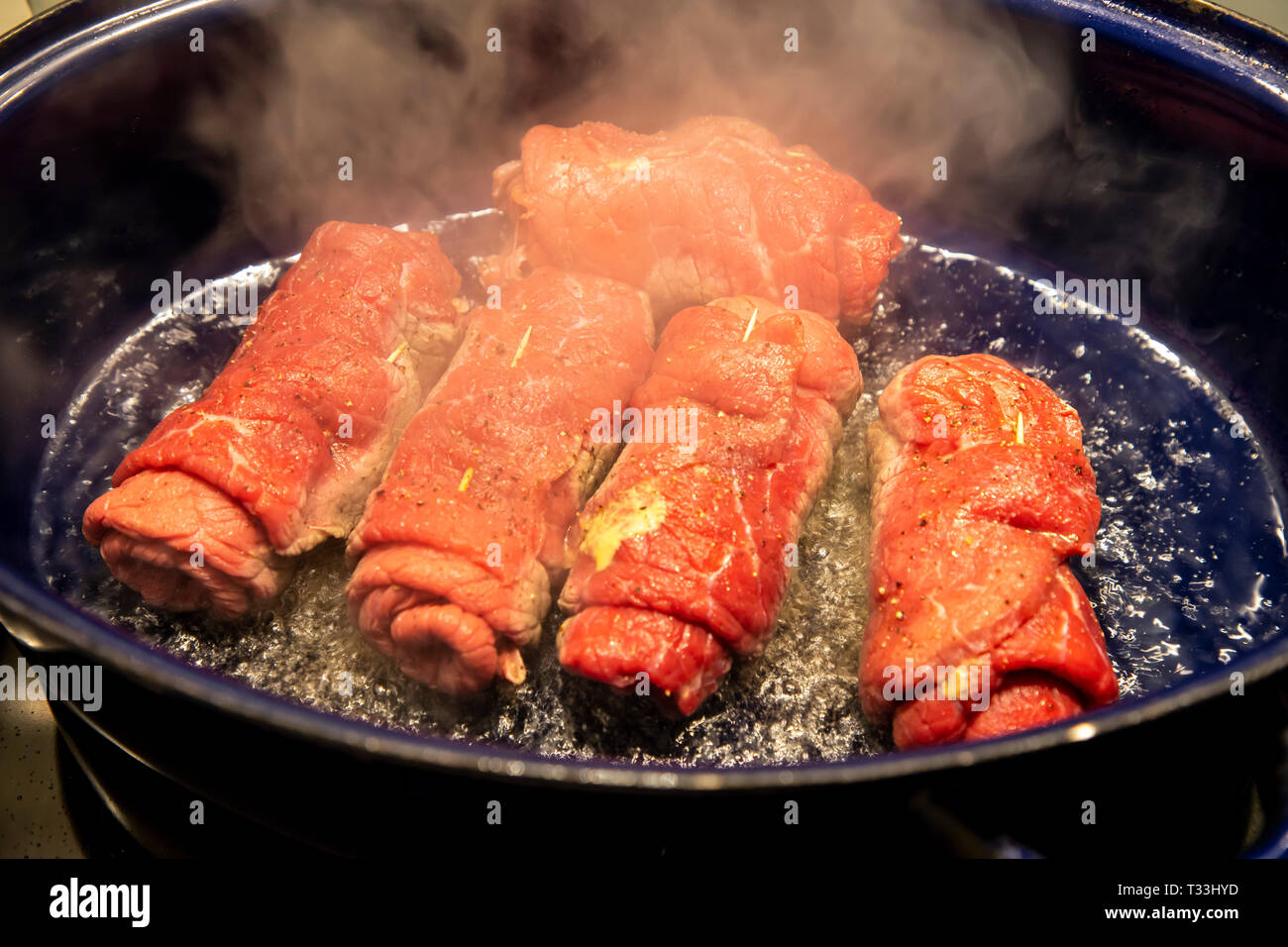 Beef roulades are seared in a breeder, Stock Photo