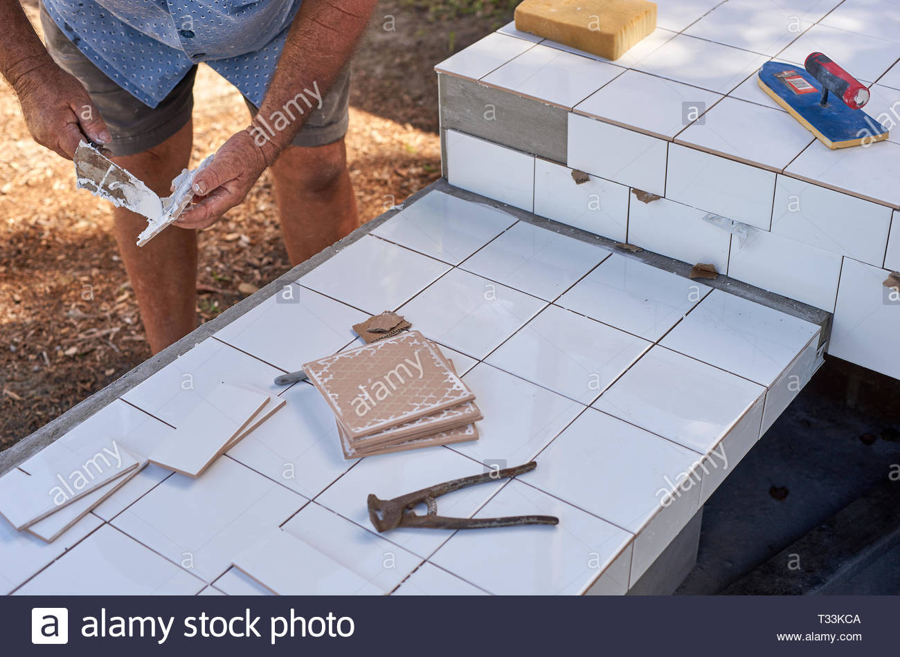 A Retired Tiler Applies The Finishing Touches To His Bbq