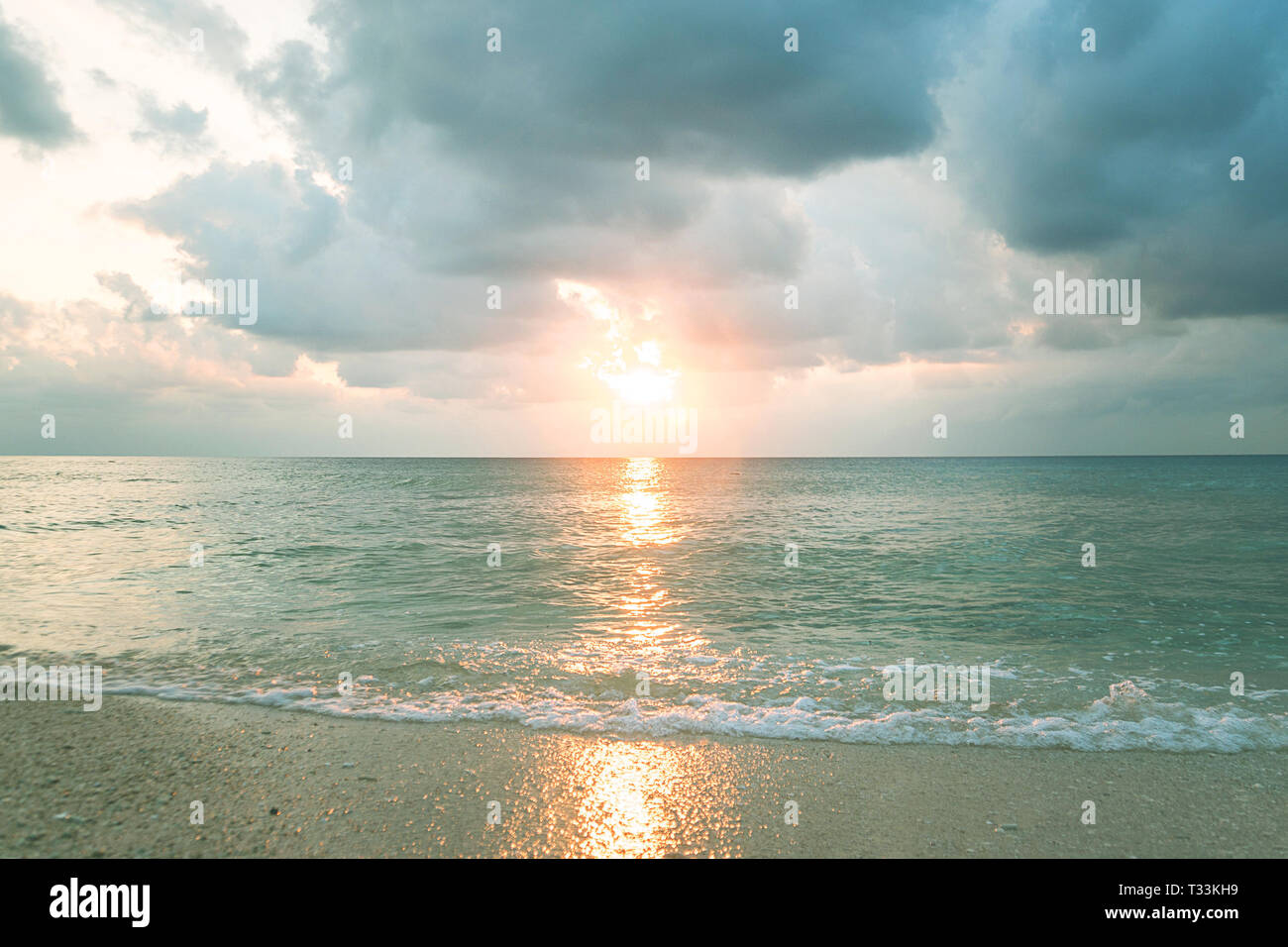 The sun on dramatic sky over sea. Natural background. Forces of nature concept. Light evening light. Clean clear water. Cloudy sky. There is a calm se Stock Photo