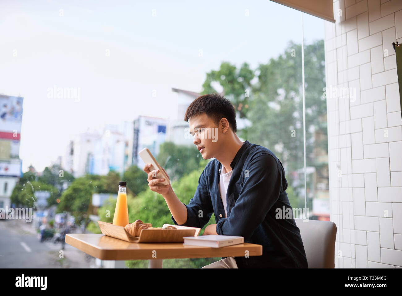 Men use phone on tea time, using mobile smart phone, Internet of things lifestyle with wireless communication and internet with smartphone. Stock Photo