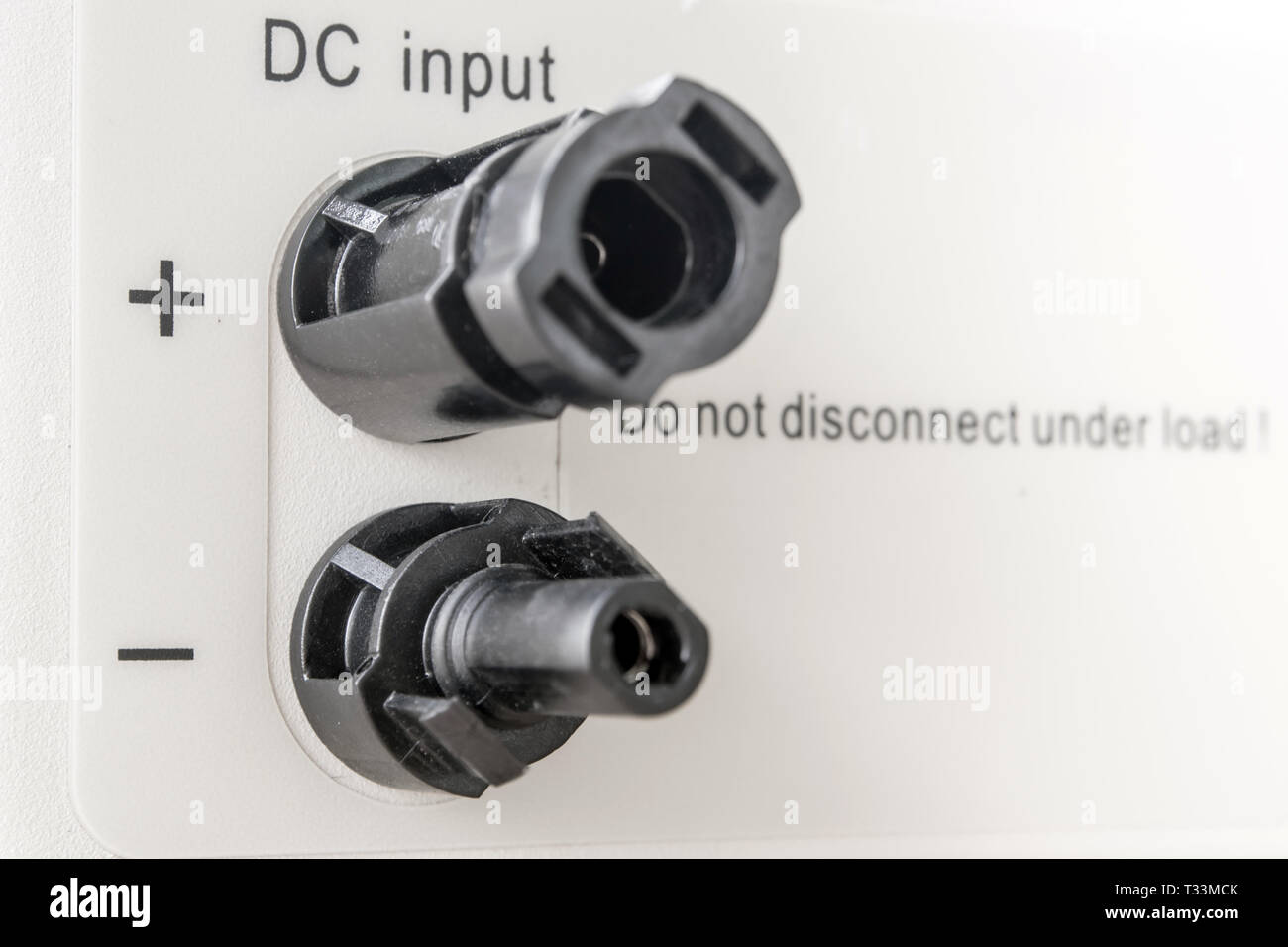 Male and Female MC4 connectors on bottom side of power inverter for connect to solar panel Stock Photo