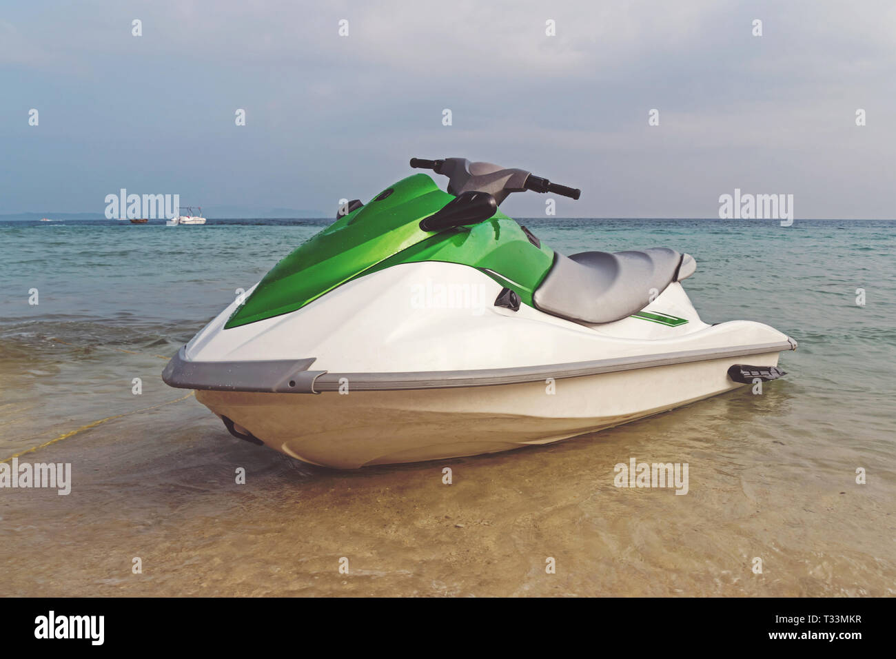 white-green jet ski parked on the shore amid a beautiful sea landscape. water entertainment at sea. summer tourist vacation at the sea. Stock Photo