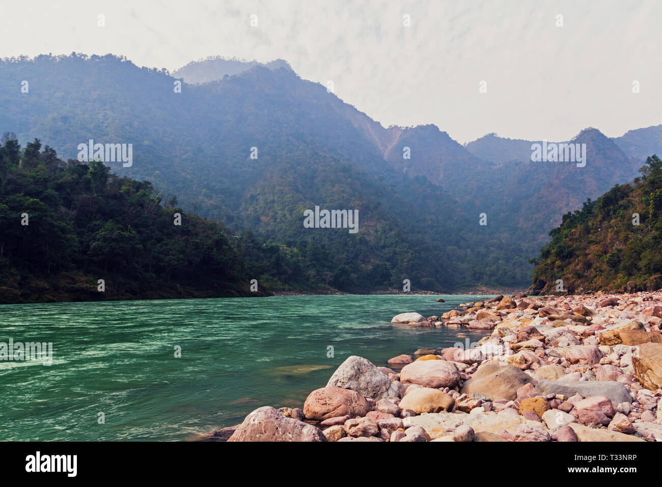 Landscape near the city of Rishikesh India with the sacred river Ganges and mountains. Beautiful mountain landscape with a mountain river in the Himal Stock Photo
