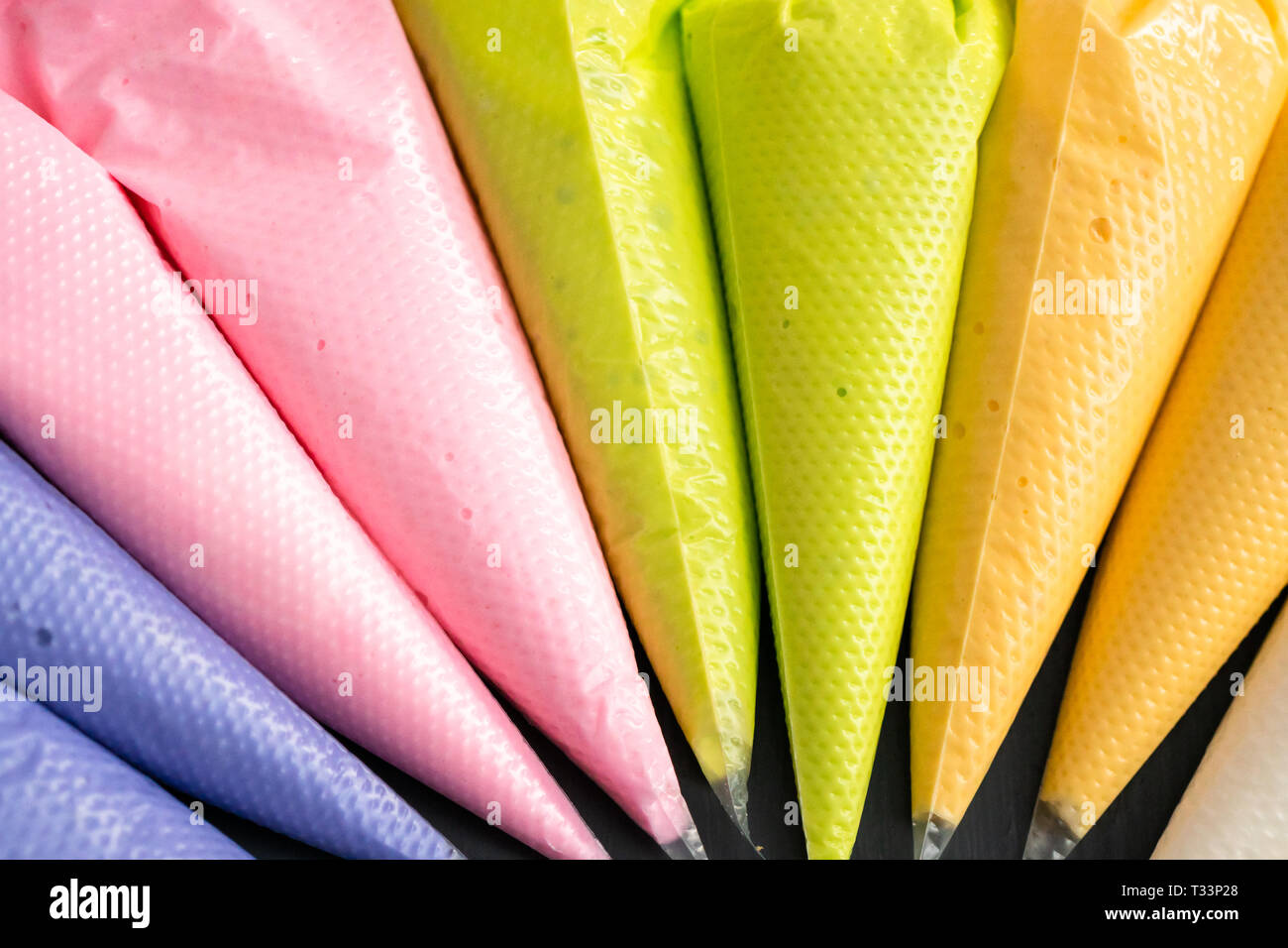 Variety of colors of royal icing in plastic piping bags Stock Photo Alamy