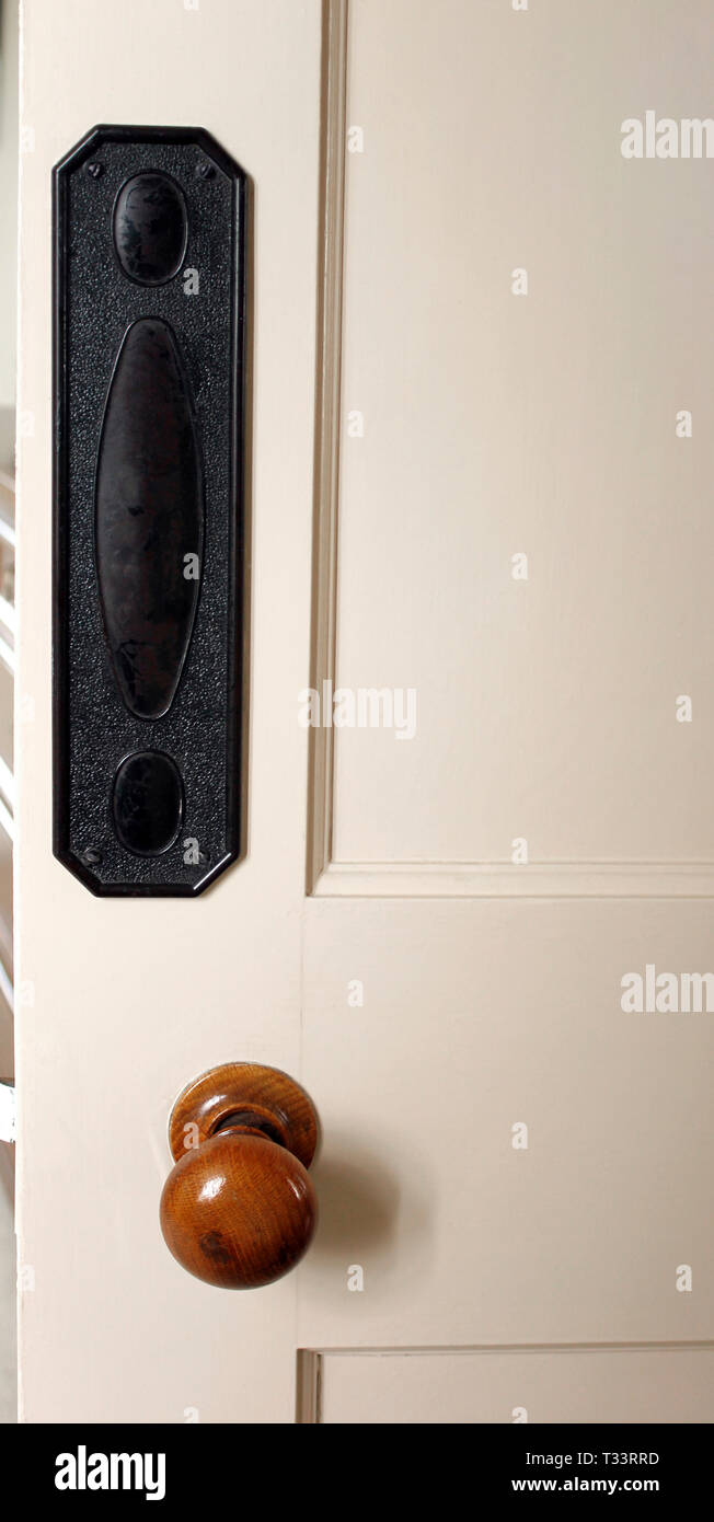 Door Finger Plate and round wooden door handle Stock Photo