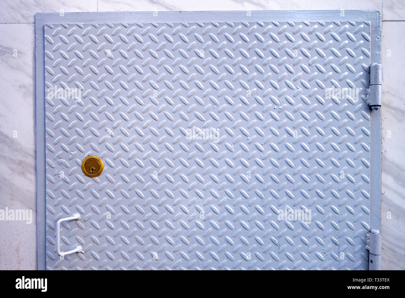 painted diamond streel door with bronz lock and handle Stock Photo