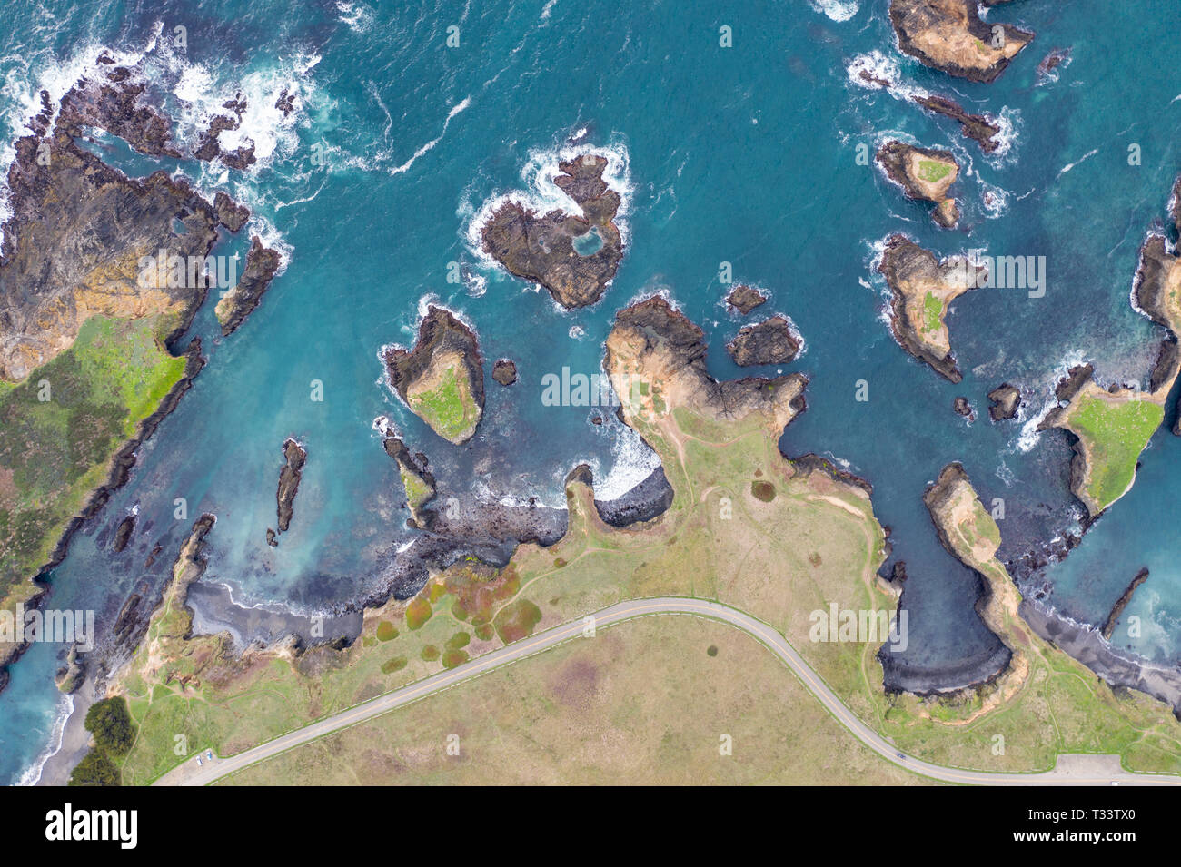 The cold waters of the Pacific Ocean wash against the scenic and rugged