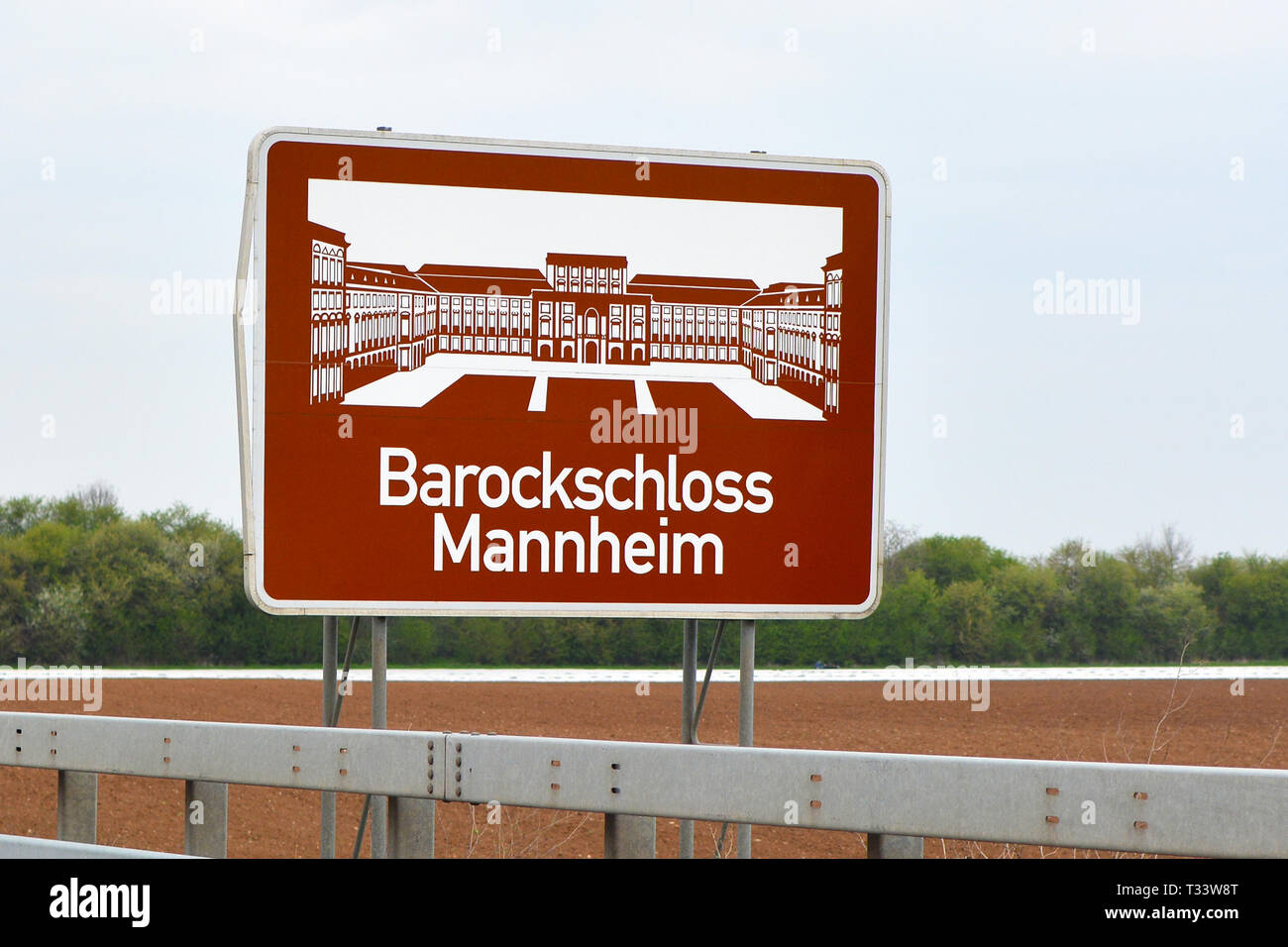 Road sign marking city border saying 'baroque palace Mannheim' with drawing of local landmark Stock Photo