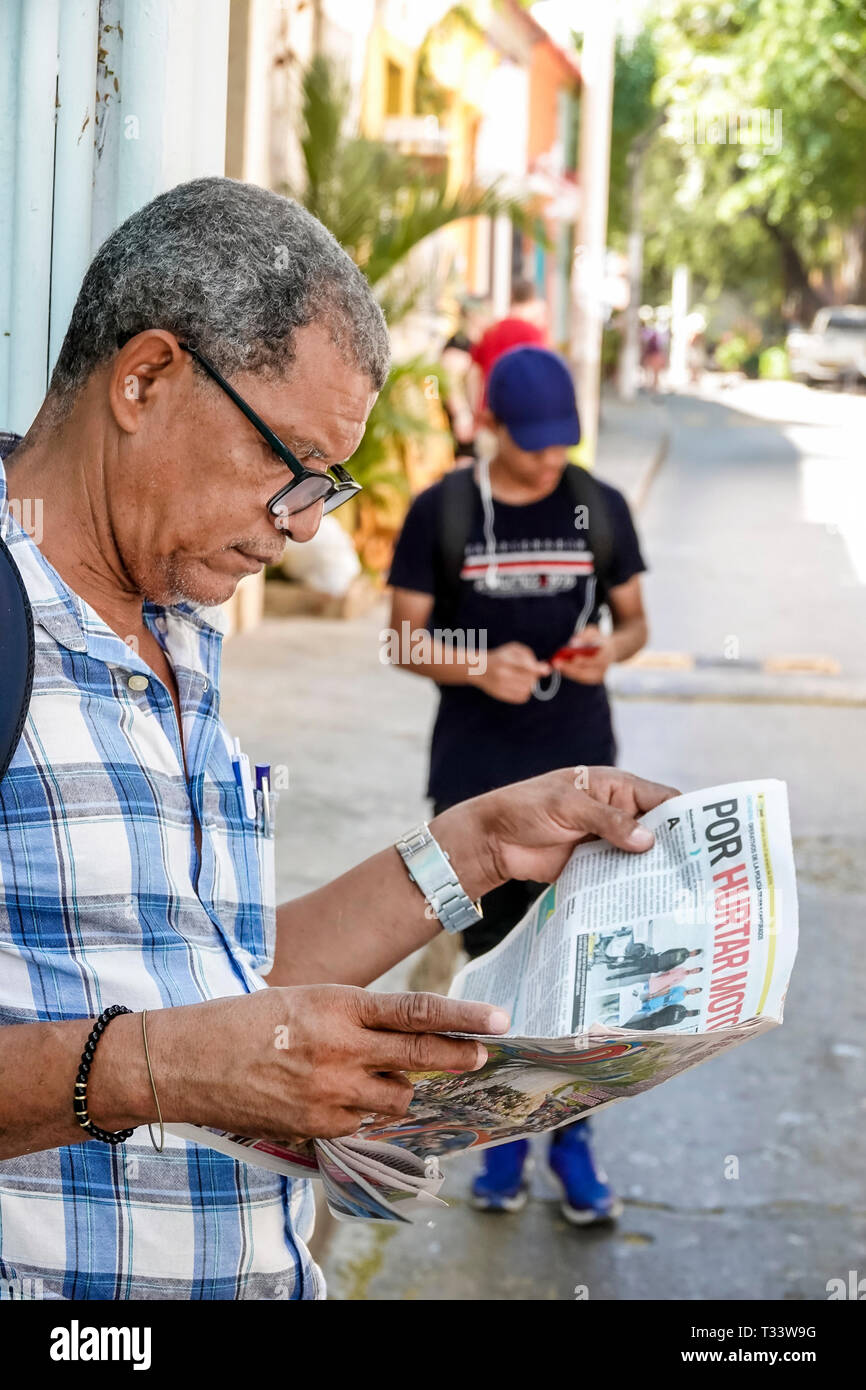 Cartagena Colombia,Center,centre,Getsemani,Hispanic resident residents,man men male,reading newspaper,Spanish language,COL190121065 Stock Photo
