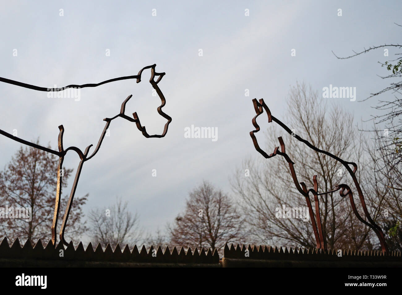 Outdated iron silhouette sculptures in the shape of German Boxer dogs with cropped ears and tails, a practice prohibited in Germany in modern days Stock Photo