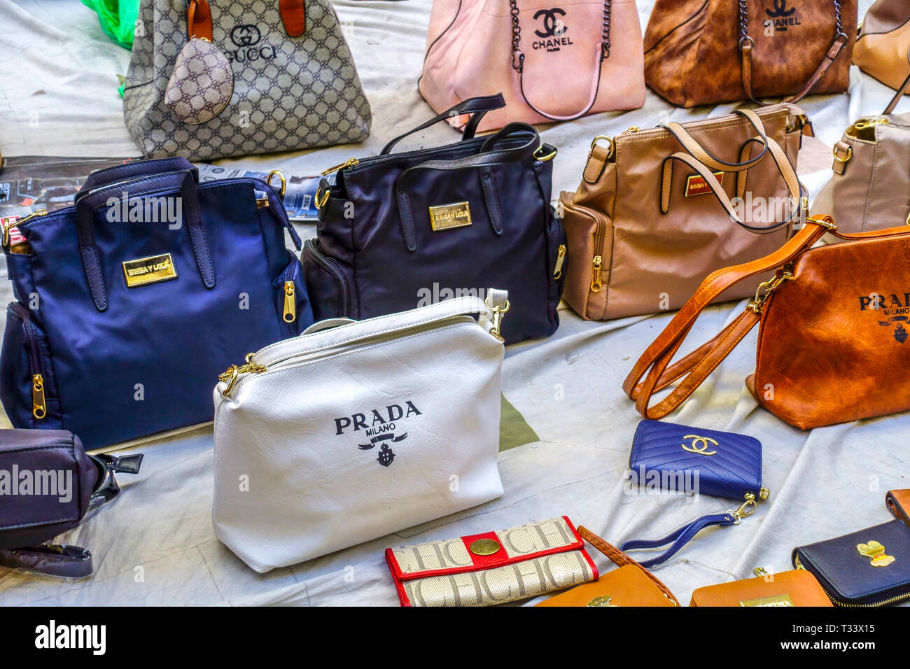 Fake world-famous brands, fake Prada handbags, Gucci bags Valencia Spain street sale Stock Photo