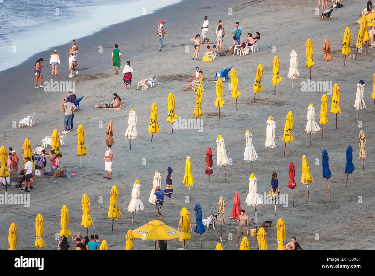 Colombia, Cartagena, Bocagrande, Caribbean Sea public beach, sand water, umbrellas yellow rental, Hispanic Hispanics Latin Latino Latinos ethnic ethni Stock Photo