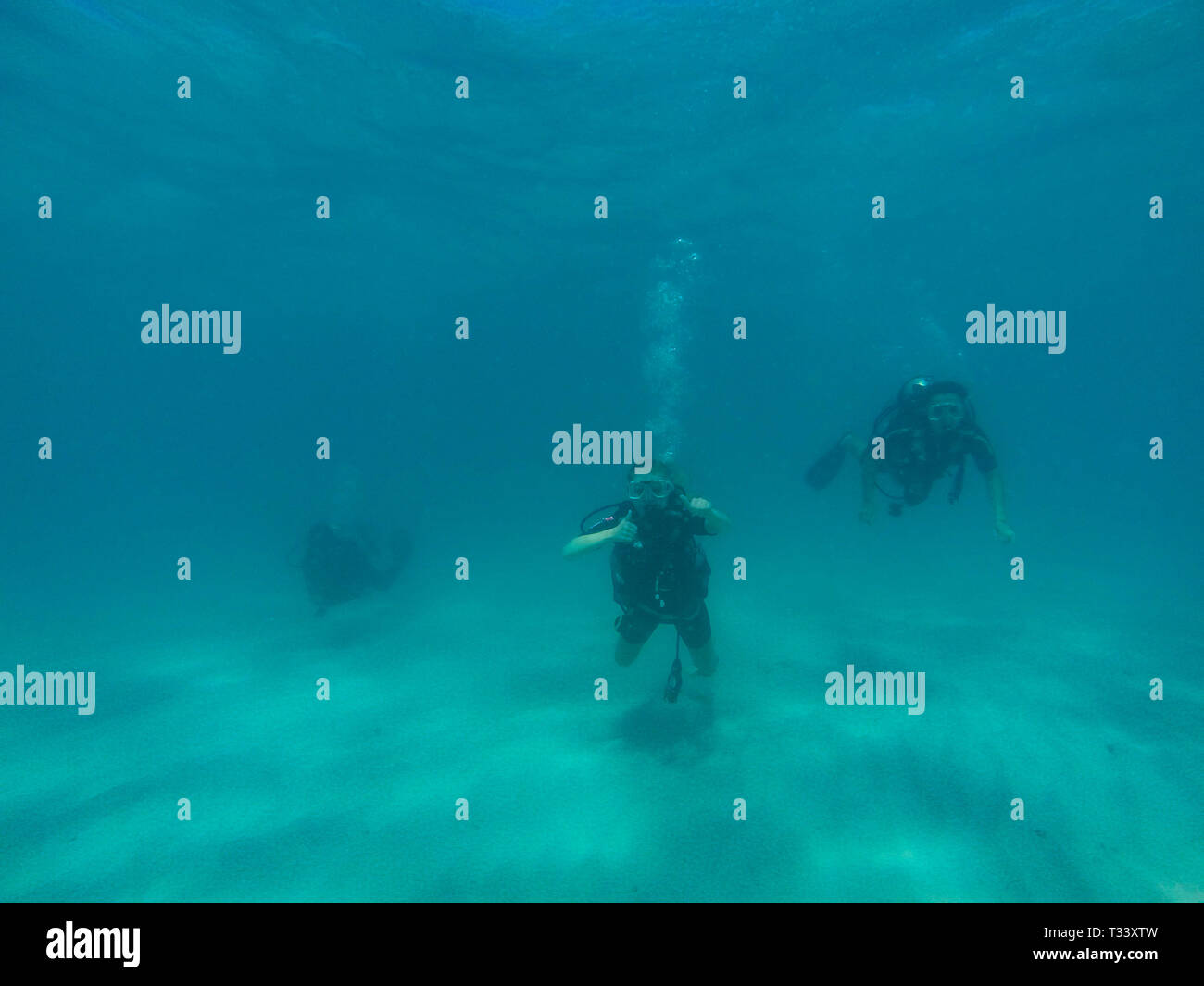 GREAT BARRIER REEF, AUSTRALIA OCT 13, 2015 3 Scuba diving tourist are swimming at the great