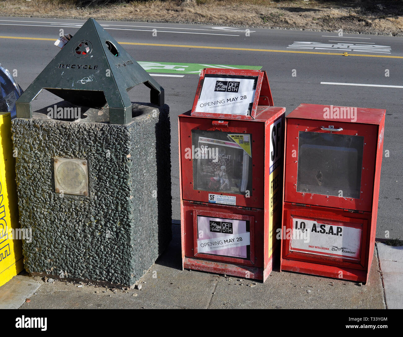 publication boxes and trash can on San Francisco sidewalk, California Stock Photo