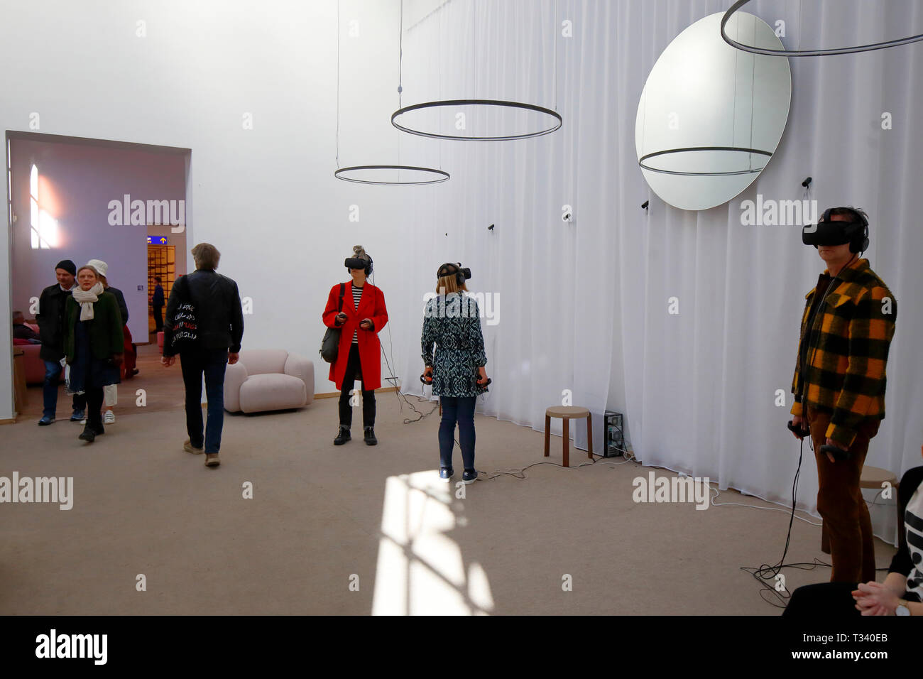 People immersed in virtual reality simulations at INTER:ACTIVE exhibition during CPH:DOX film festival held in Kunsthal Charlottenborg, Copenhagen Stock Photo