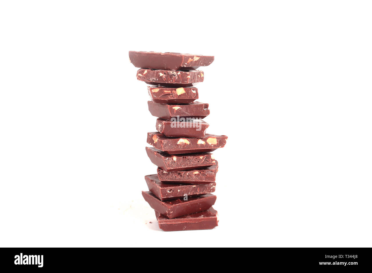 high stack of slices of original milk chocolate .isolated on white Stock Photo