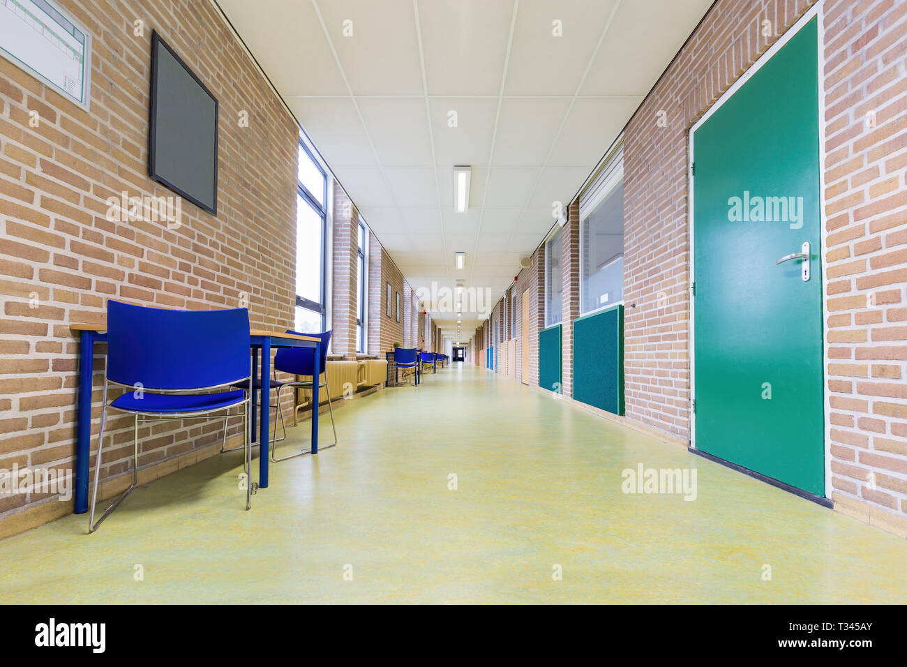 Straight long and abandoned corridor in high school Stock Photo