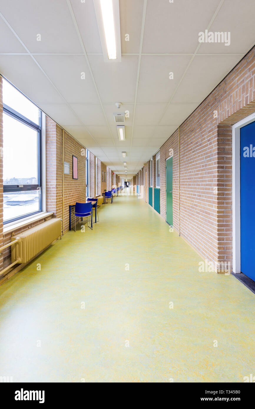Long straight and empty corridor in secondary school building Stock Photo