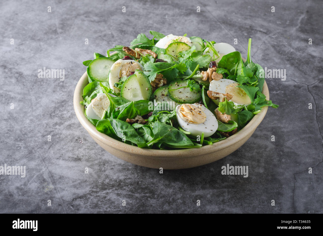 Delicious and simple healthy salad with nuts, eggs and cucumber Stock