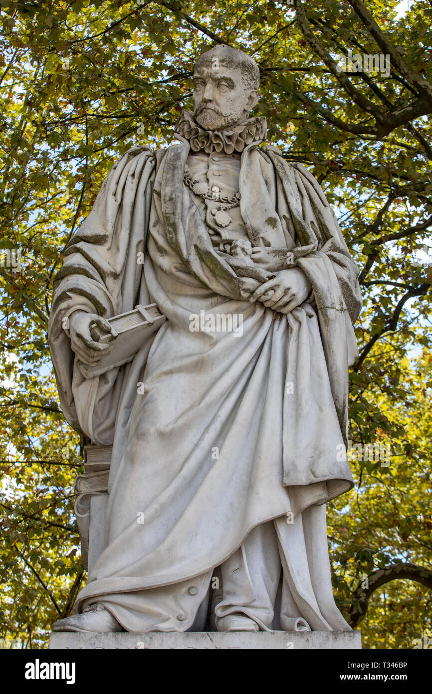 Statue of Michel de Montaigne in public garden along Place des