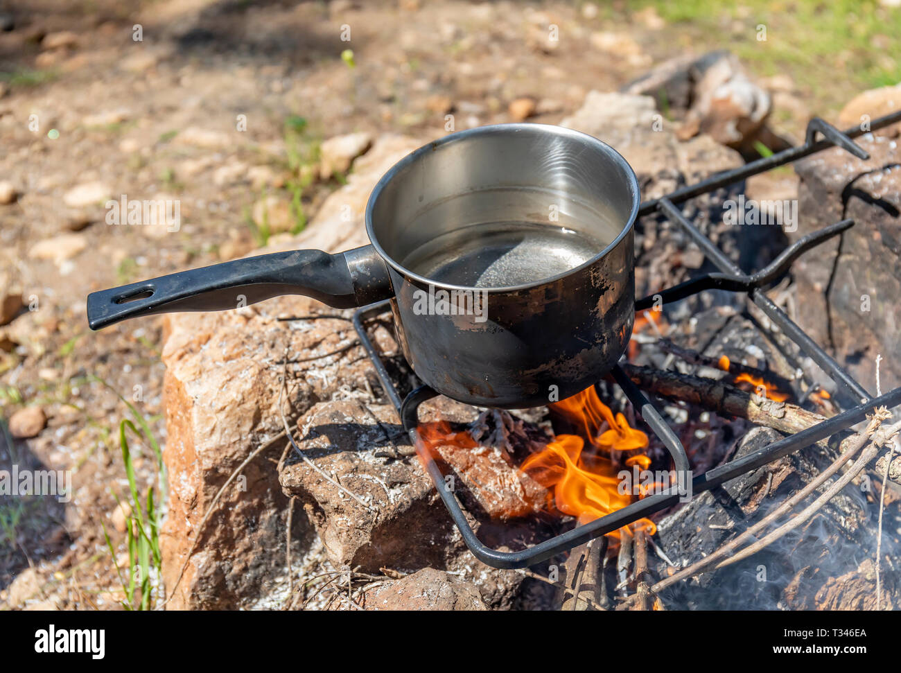 https://c8.alamy.com/comp/T346EA/a-sooty-pot-of-water-about-to-boil-above-a-campfire-T346EA.jpg
