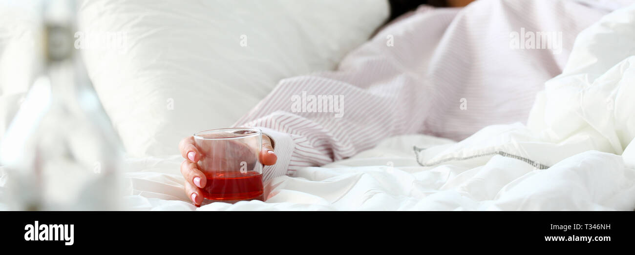 Young woman lying in bed deadly drunken Stock Photo