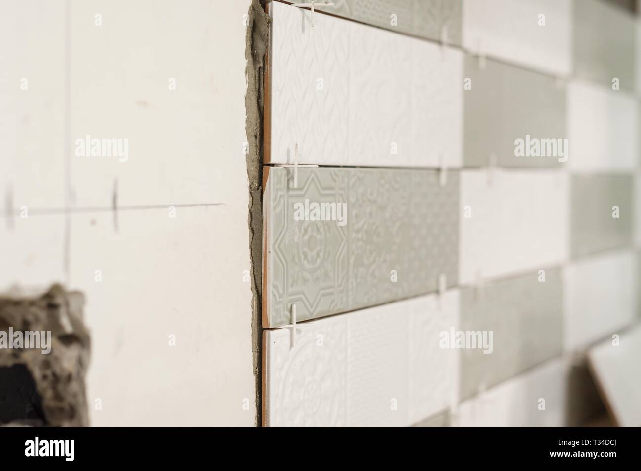 Process of laying ceramic tiles, construction and repair in the kitchen, tiles. Stock Photo