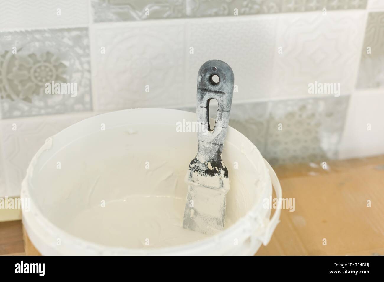 Bucket of decorative, acid resistant epoxy grout for