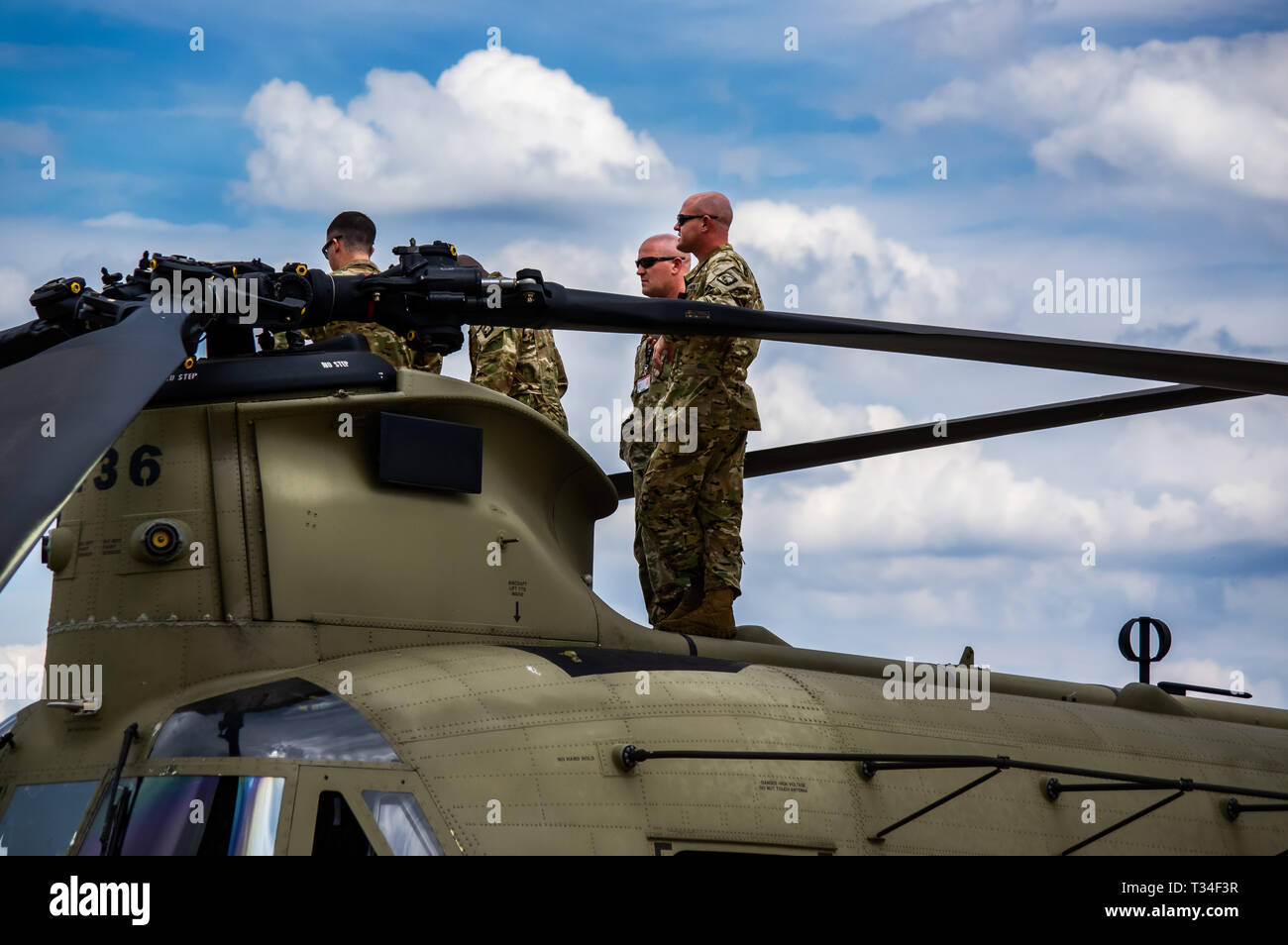 A Boeing Chinook on static display, with the crew on the top watching the air display at the Farnborough air show 2018 Stock Photo