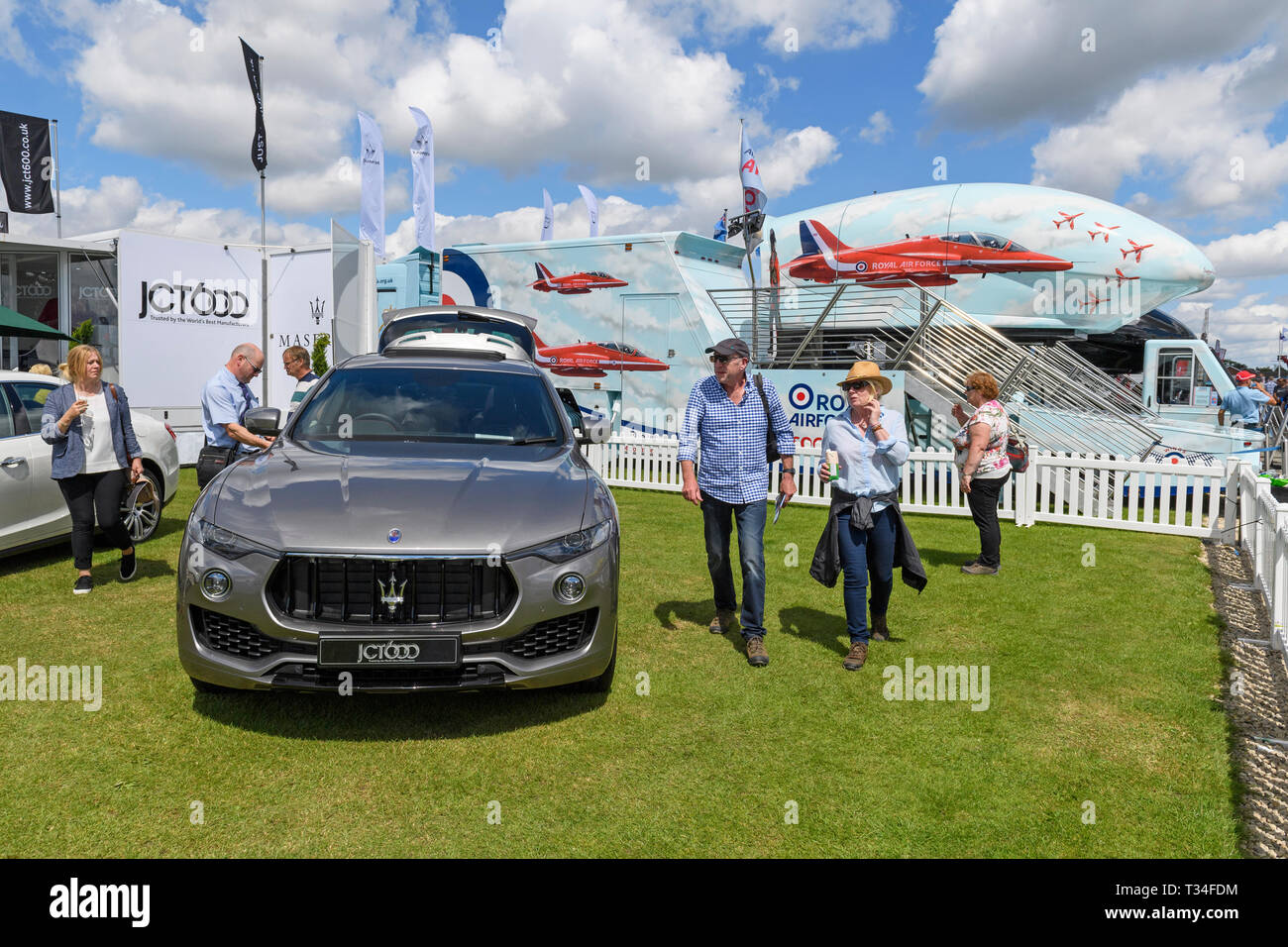 Sunny day out for people looking at grey Maserati Levante (luxury SUV car) parked on JCT600 trade stand - Great Yorkshire Show, Harrogate, England, UK Stock Photo