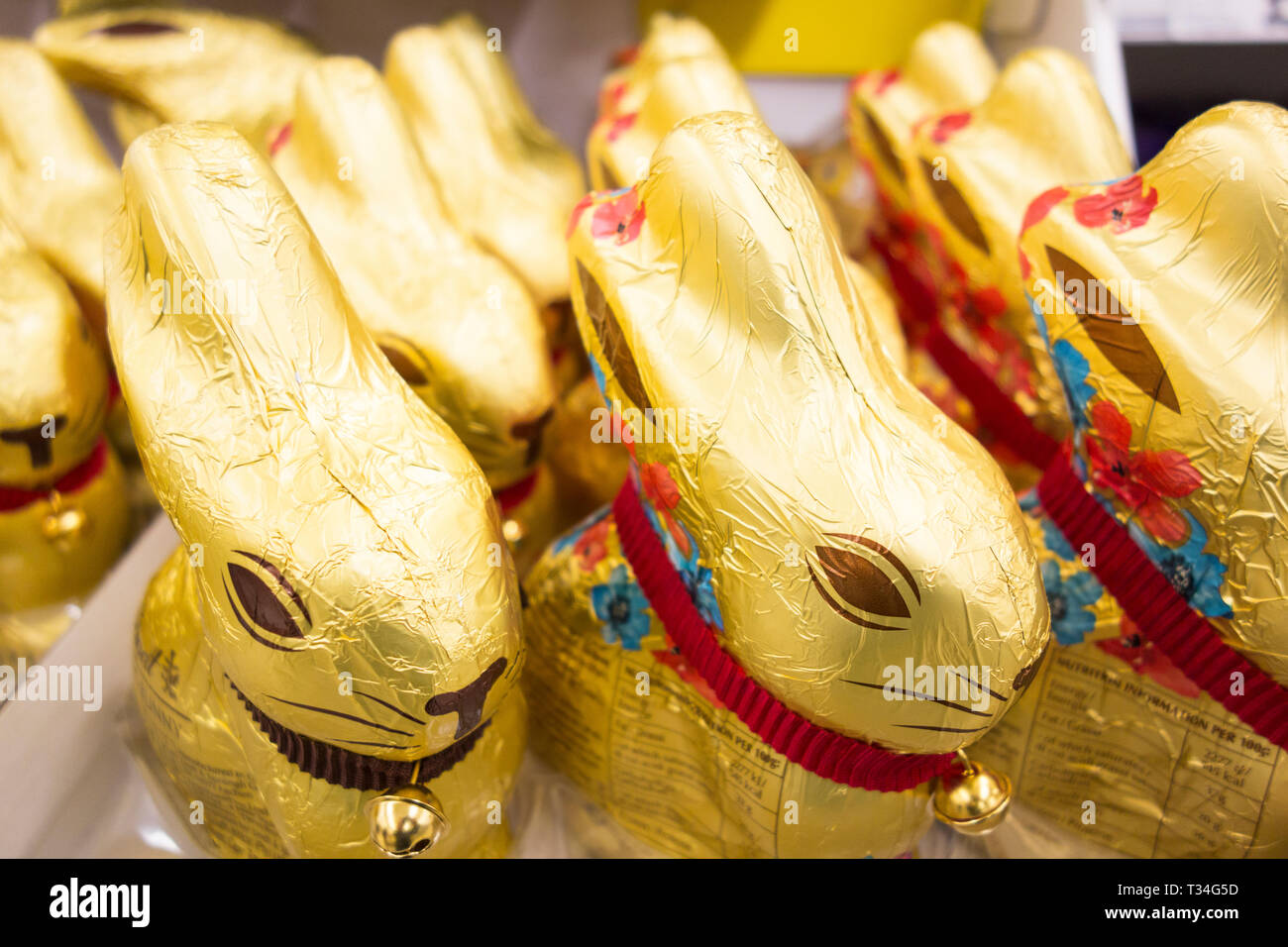 Lindt Golden Milk Chocolate and Dark chocolate bunnies on a supermarket shelf in the UK Stock Photo