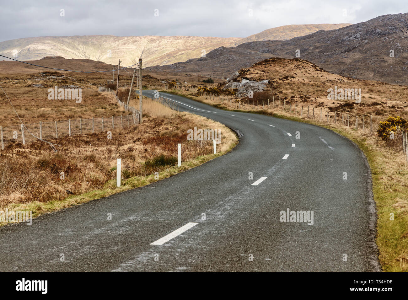 Conemara road and bog with mountains in background, Maam Cross, Galway, Ireland Stock Photo